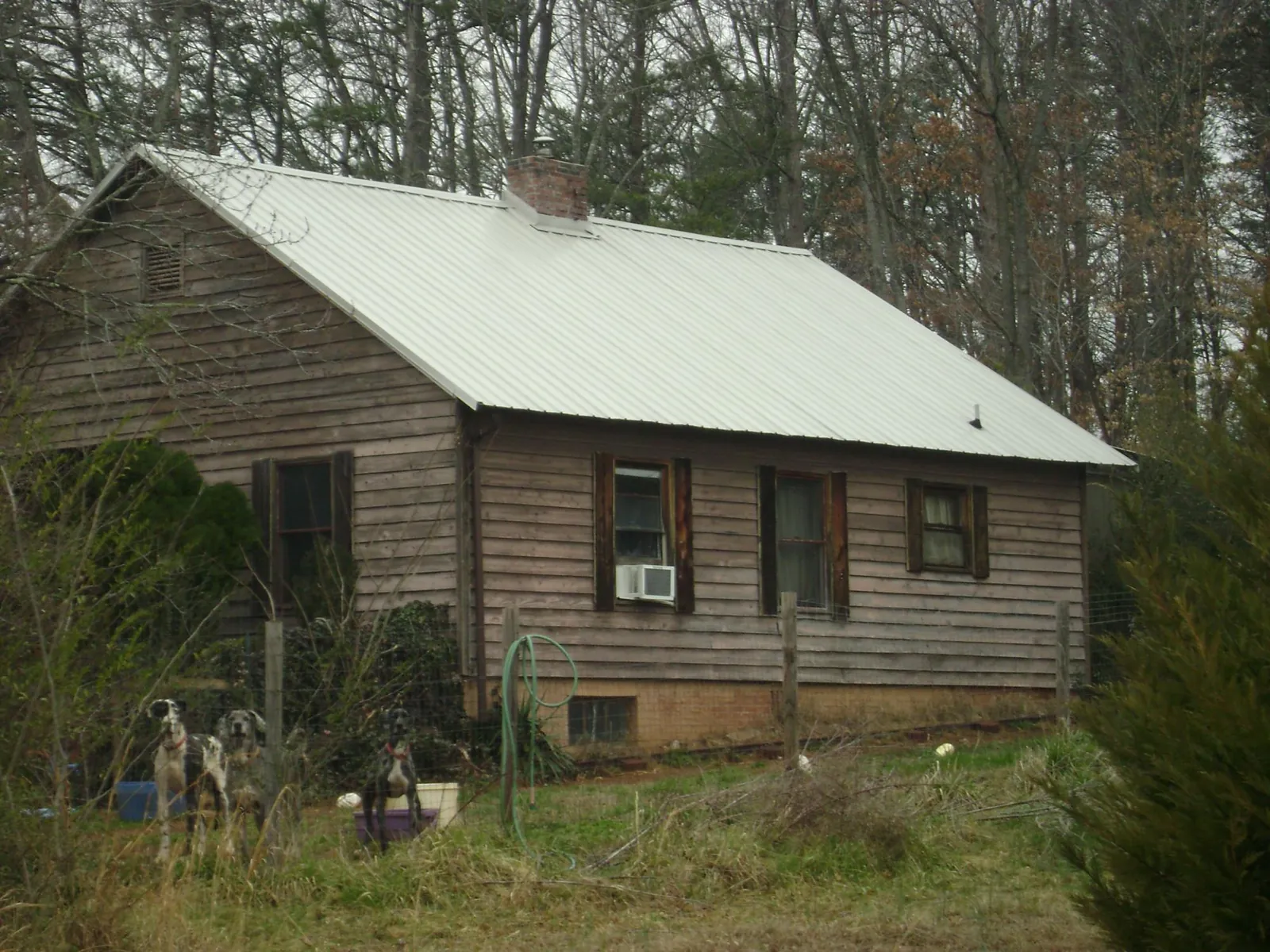 White metal roof on an old wood sided farmhouse, from a Metal Roof Installation job in Montross